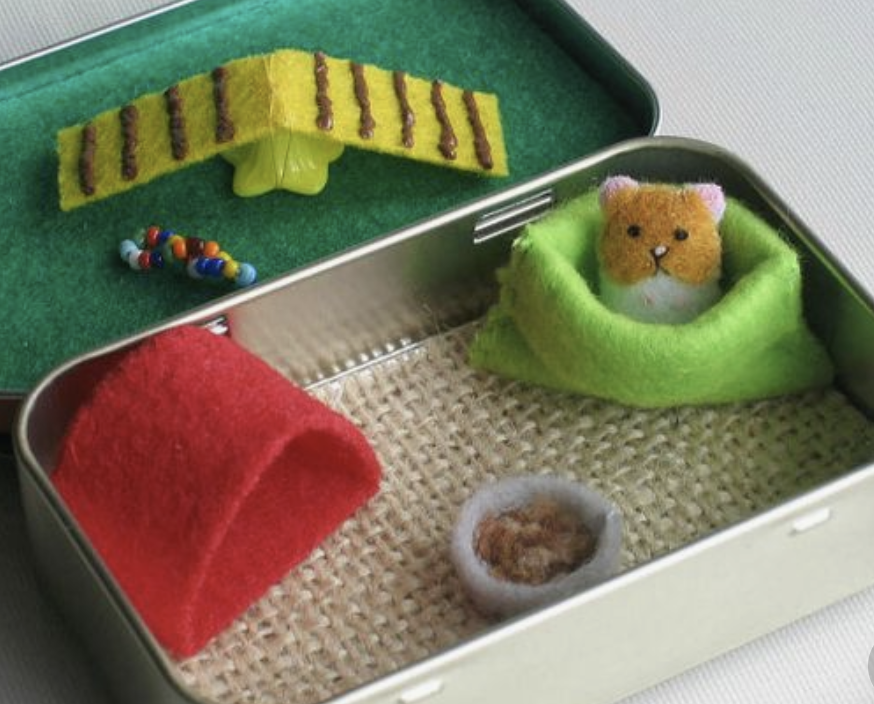 teeny hamster house out of a candy tin