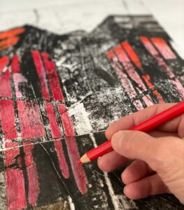 hand coloring a drawing of a building