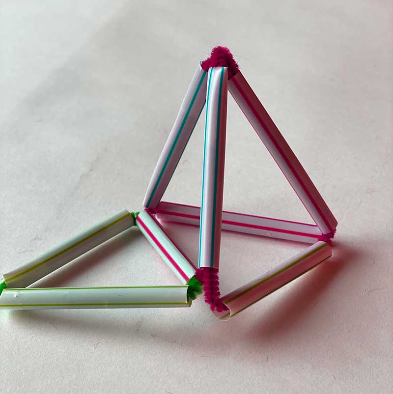 small structure made of straws and pipe cleaners