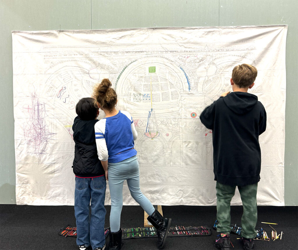kids drawing on a mural during the chicago architecture biennial 2024 at the chicago cultural center with archKIDecture
